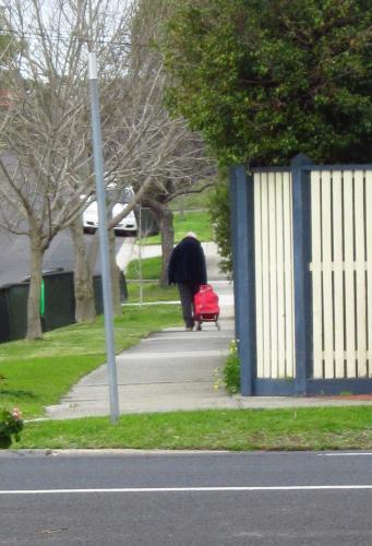 Old lady walking up Pollina Street