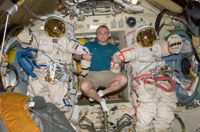 Maxim Suraev with Orlan spacesuits